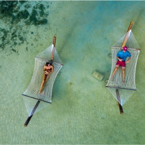 hammocks over water at mahogany bay beach club
